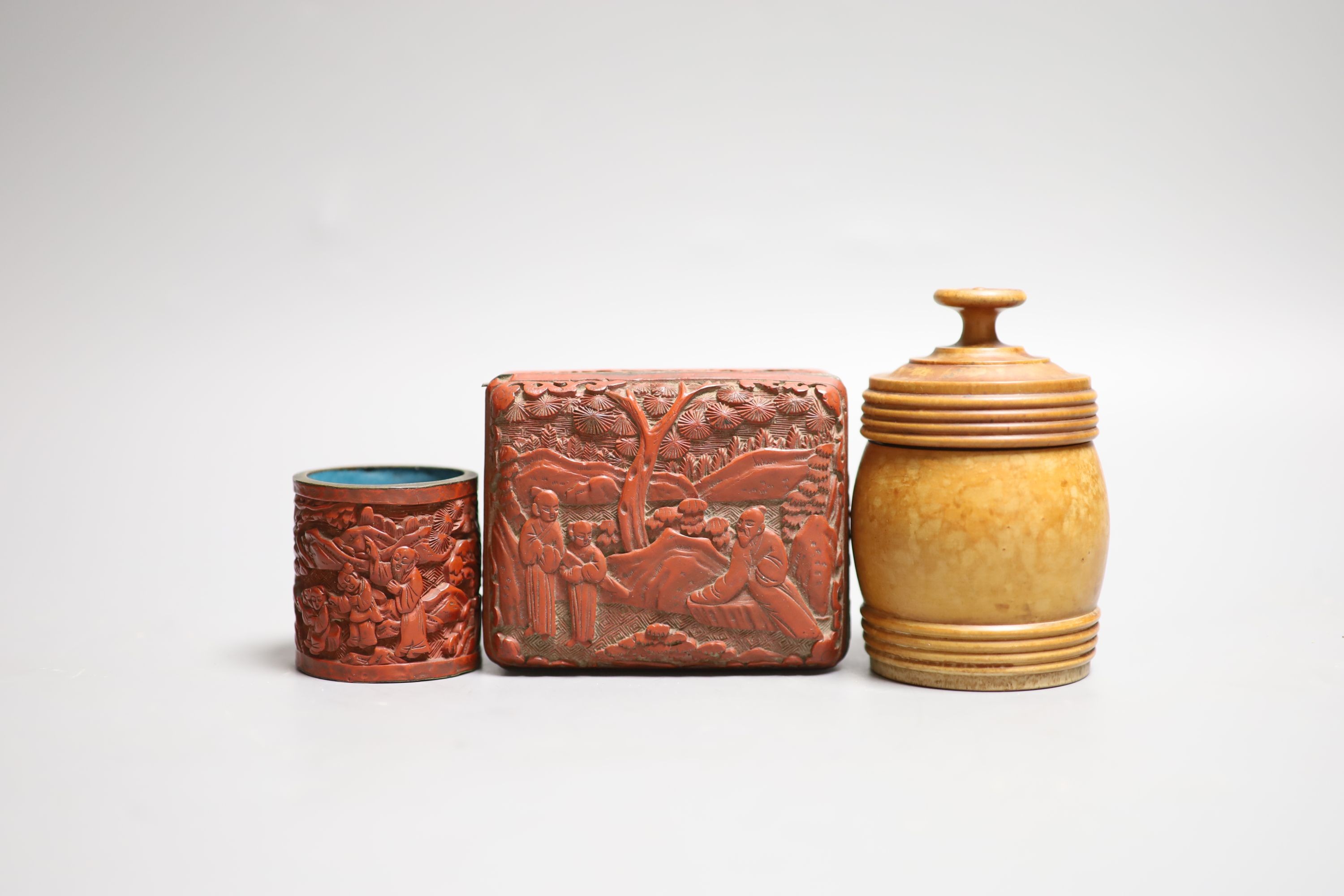 A Chinese cinnabar lacquer cigarette box and cover, 10cm and a similar match holder and a Dutch treen match holder